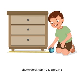 Cute little boy measuring width of furniture with tape