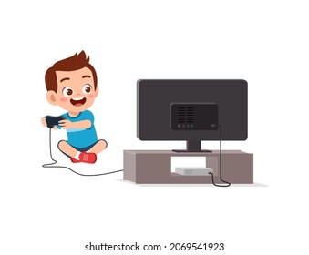 cute little boy play video game on big screen