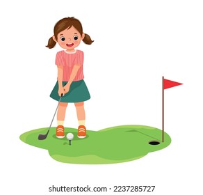 Cute little boy playing golf ready to hit ball aiming at the hole