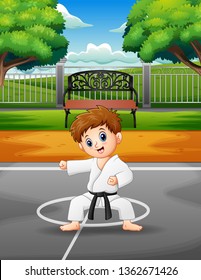 Cute little boy practicing karate outdoors