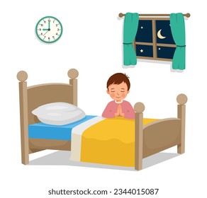 Cute little boy praying before going to bed in the bedroom