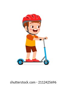 cute little boy riding scooter and wear helmet