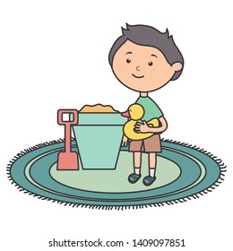 cute little boy with sand bucket and ducky