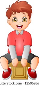 Cute little boy sitting on a cube