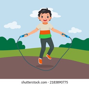 cute little boy skipping jumping rope at the park