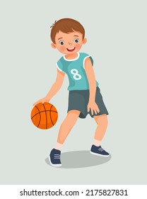 cute little boy with sportswear playing basketball dribbling the ball in action