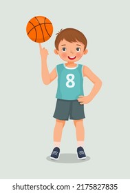cute little boy with sportswear spinning basketball on his finger posing with hand on his waist