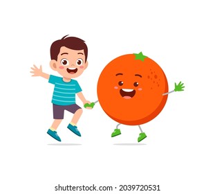 cute little boy stands with orange character