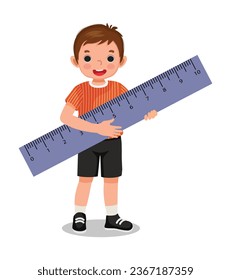Cute little boy student holding big ruler