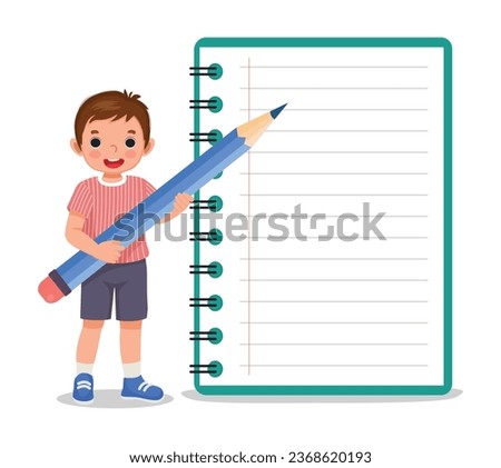Cute little boy student holding big pencil standing with big notebook
