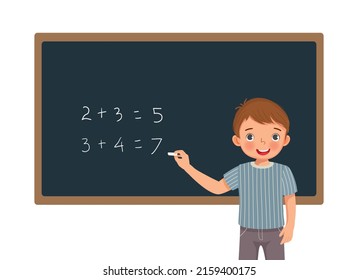 cute little boy student writing with chalk math equation solution on the blackboard in front of class