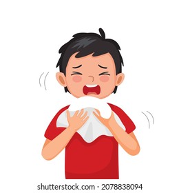 Cute little boy suffering from flu or cold allergy symptom sneezing on a handkerchief or tissue paper.