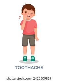 Cute little boy suffering from toothache touching her painful cheek