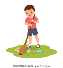 Cute little boy sweeping trash in the yard with broom