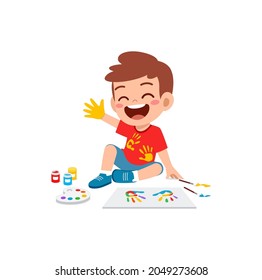 cute little boy using paint to hand for art