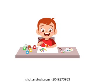 cute little boy using paint to hand for art