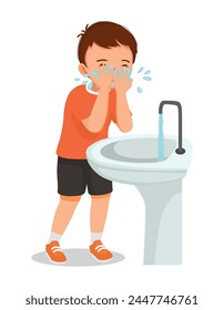 Cute little boy washing face at the sink in the morning