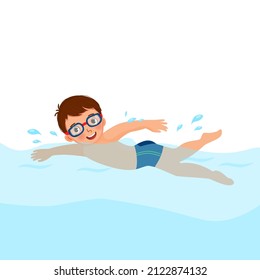 cute little boy wear googles enjoying swimming in a pool