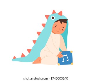 Cute little boy wearing dinosaur costume playing with music box vector flat illustration. Adorable toddler in romper suit sitting with toy cube isolated on white. Lovely child in funny apparel