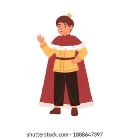 Cute little boy wearing king costume at carnival party vector flat illustration. Funny kid in mantle and crown waving hand isolated. Male actor of childish theater taking part at performance