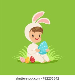 Cute little boy in a white bunny costume playing with colorful eggs, kid having fun on Easter egg hunt vector Illustration