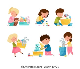 Cute little boys and girls cleaning up his toys and putting toys into boxes set. Kids doing housework chores at home cartoon vector illustration