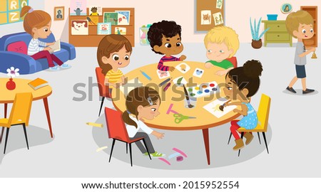 Cute little boys and girls spending time at international class room art handicraft lesson