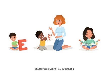 Cute Little Boys and Girls Studying Alphabet with Their Teacher Set, Elementary Students and Tutor Sitting on Floor in Kindergarten, Kids Education and Upbringing Vector Illustratio