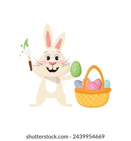 Cute little bunny, armed with a brush, is busy adding colorful designs to eggs for Easter. A basket filled with beautifully decorated eggs