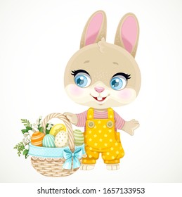 Cute little bunny standing near a large basket with painted Easter eggs isolated on white background