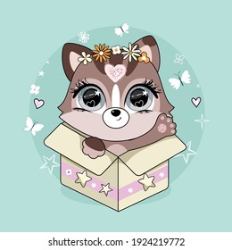 Cute little cat with floral wreath sitting in the box.