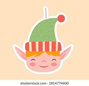 Cute little elf Christmas tree ornament with pointy ears and happy grin over a pastel background, colored vector illustration