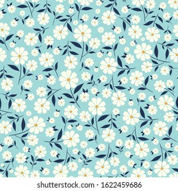 Cute little flowers seamless pattern with light blue background