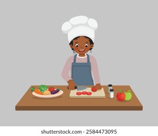 Cute little girl African chef cooking meal cutting slicing tomato vegetable with knife in the kitchen