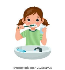 cute little girl brushing teeth and toothpaste holding glass water for cleaning daily routine hygiene activity