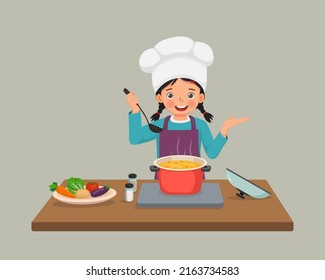 cute little girl chef cooking delicious vegetable soup with hand showing for copy space