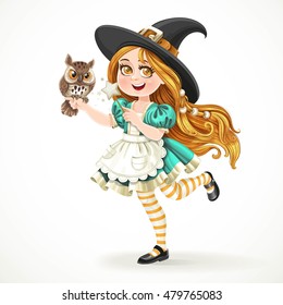 Cute little girl dressed as witch with a owl and magic wand standing on a white background