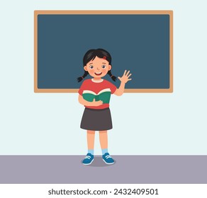 Cute little girl holding book standing in front of class reading speaking