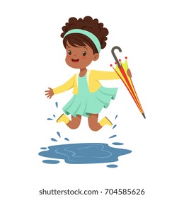 Cute little girl holding colorful umbrella and playing in the rain cartoon vector Illustration