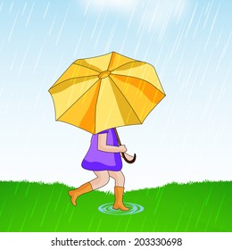 Cute little girl holding an umbrella in under heavy rains on nature background. 