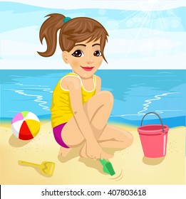 cute little girl playing with sand on beach