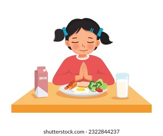 Cute little girl praying before eating breakfast at the table