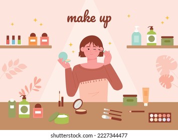 A cute little girl is putting on makeup on the table full of makeup products.