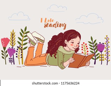 Cute little girl reading a book in the garden