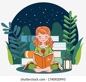 Cute, little girl reading a book in the garden