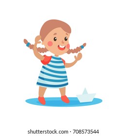 Cute little girl in sailors costume playing with paper boat, kid dreaming of becoming a sailor vector Illustration