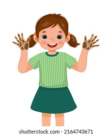 cute little girl showing her dirty hands with mud and soil dirt