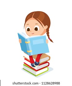 Cute little girl sitting on the pile of books and reading a book