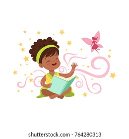 Cute little girl sitting on floor with magic book and waving by hand to imaginary pink fairy. Cartoon kid character surrounded by stars. Flat vector illustration