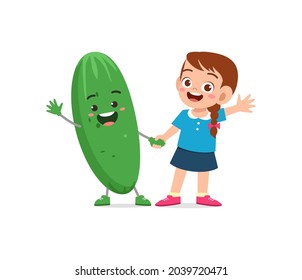 cute little girl stands with cucumber character